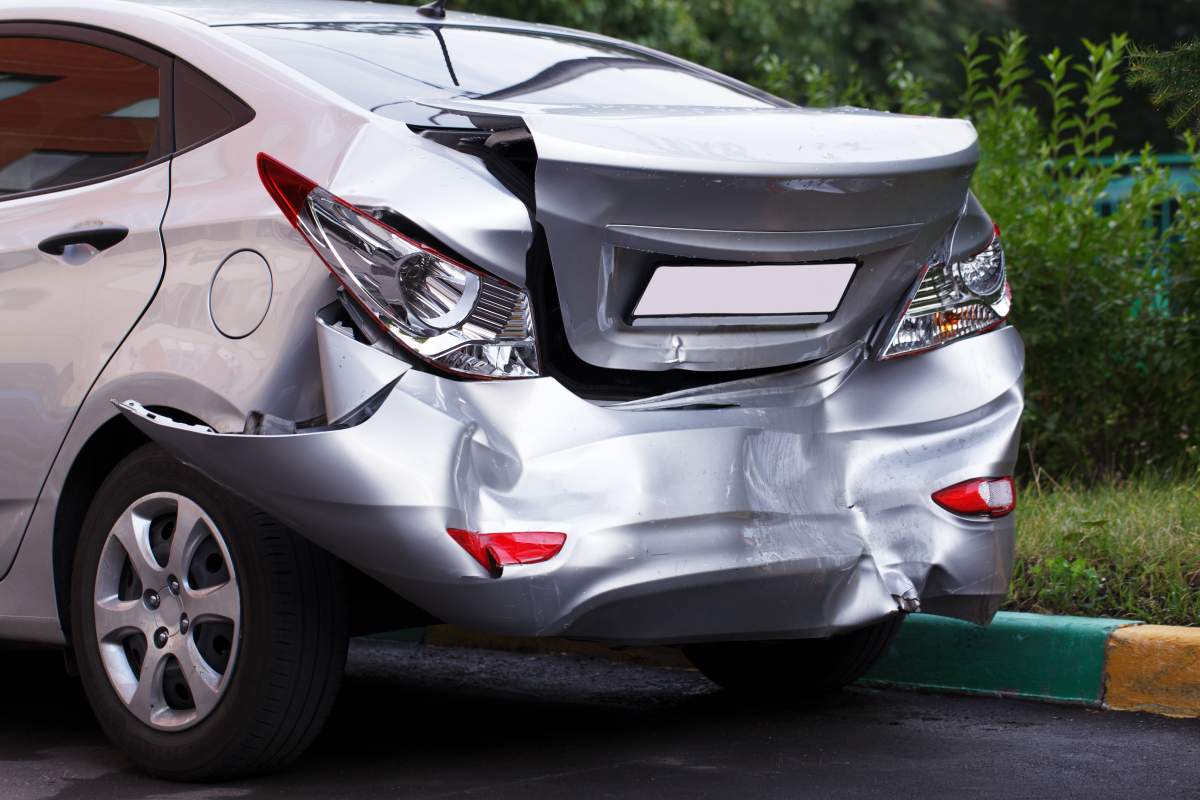 Damaged silver car after a severe rear-end collision