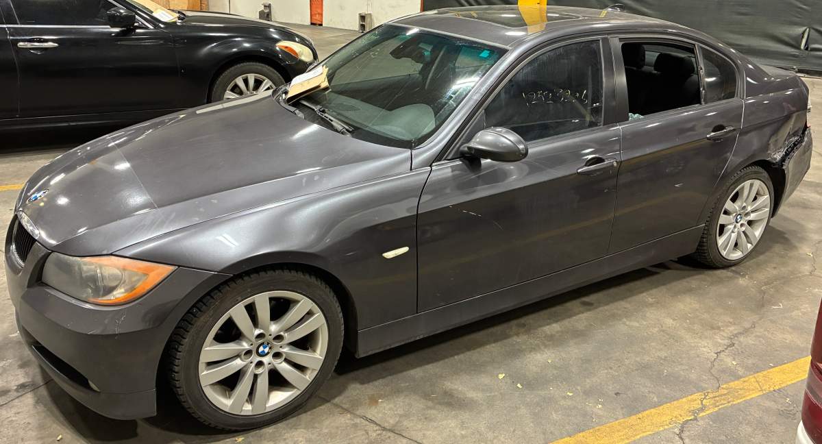 A dark grey BMW 325i sedan car driven by suspects who were arrested in the homicide of Justin Hunt at the Alberta Pipe Trades College in west Edmonton on Friday, Oct. 16, 2026.