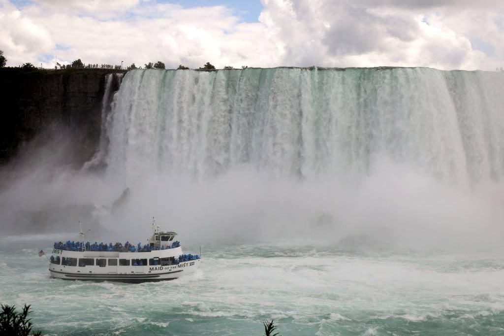 A crowded Maid of the Mist tour boat operated from the American side of the Niagara River is seen from Niagara Falls, Ont., on Tuesday, July 14, 2020.  Anti-COVID measures, particularly the closure of the U.S. border, has prompted a steep decline of visitors to one of the world's top tourist destinations. THE CANADIAN PRESS/Colin Perkel.