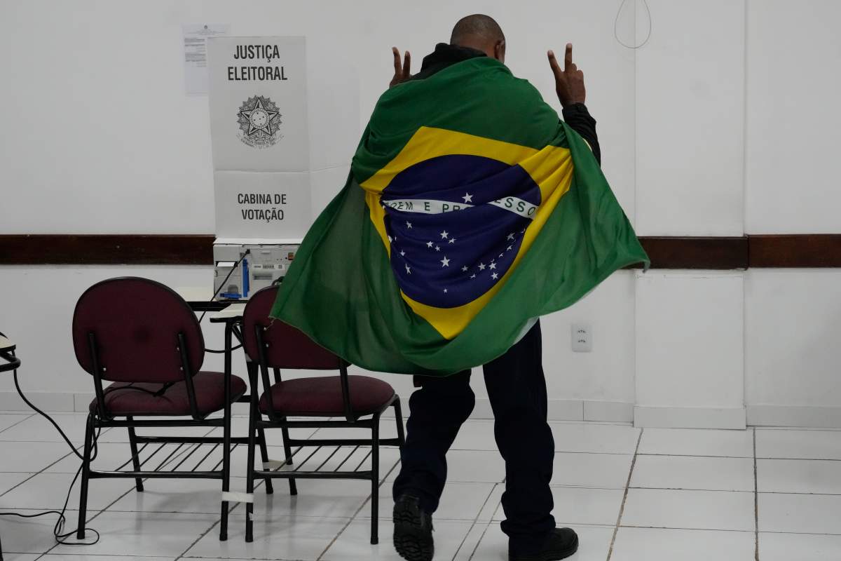 A man wrapped in a Brazilian flag arrives to vote in the presidential runoff in Brasilia, Brazil, Sunday, Oct. 25, 2026. 