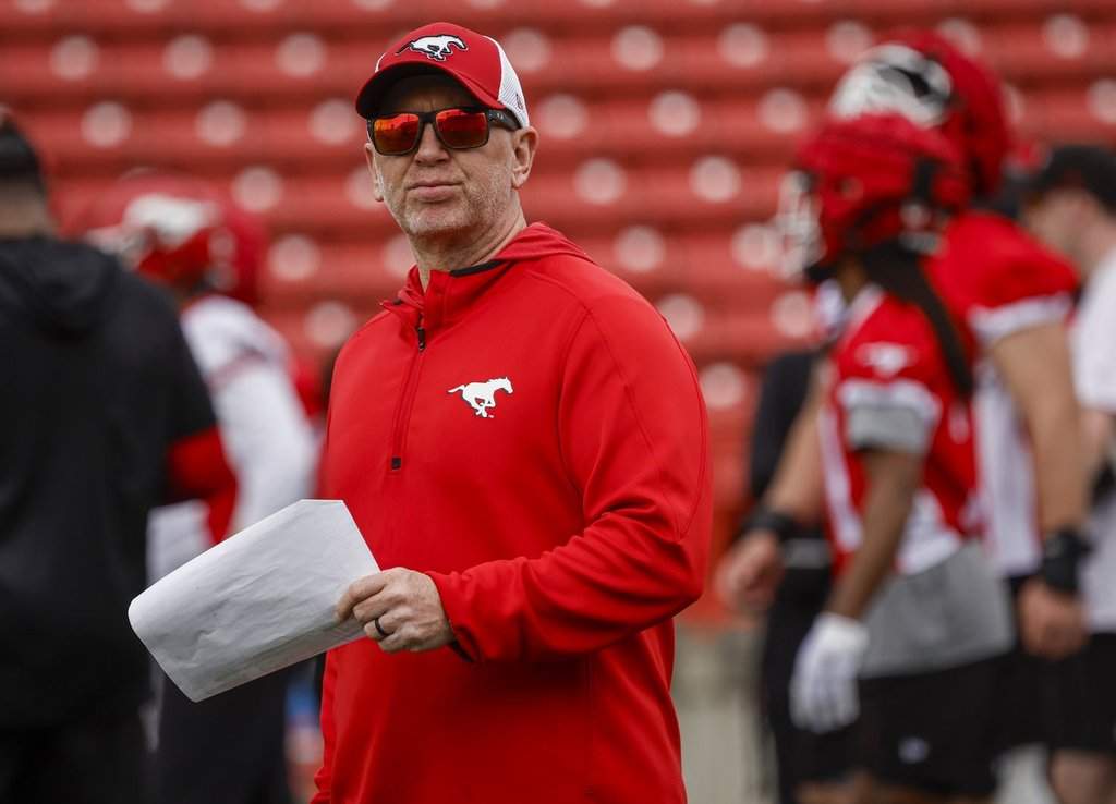 Calgary Stampeders head coach Dave Dickenson, centre, watches drills during opening day of training camp in Calgary, Sunday, May 10, 2026.THE CANADIAN PRESS/Jeff McIntosh.