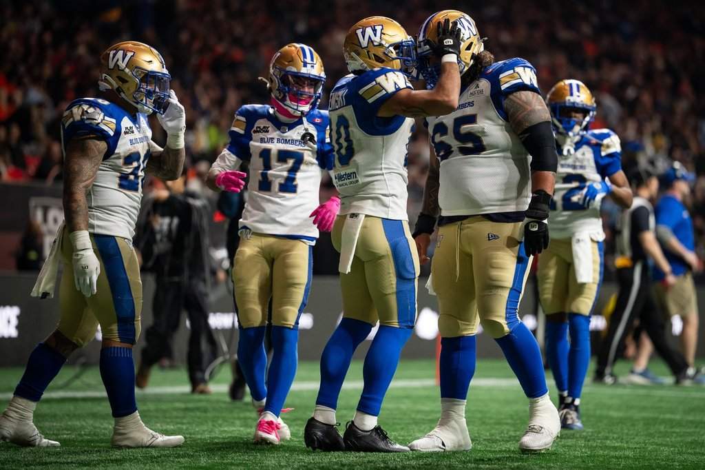 Winnipeg Blue Bombers' Nic Demski (10) celebrates his touchdown against the B.C. Lions with Winnipeg Blue Bombers' Asotui Eli (65) during the second half of a CFL football game, in Vancouver, on Friday, Oct. 23, 2026. THE CANADIAN PRESS/Ethan Cairns.