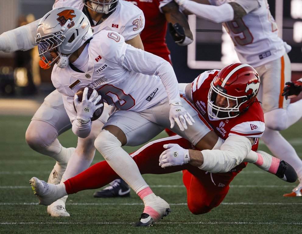B.C. Lions' Robert Carter, left, is tackled by Calgary Stampeders' Micah Teitz during first half CFL action in Calgary, Saturday, Oct. 17, 2026. THE CANADIAN PRESS/Jeff McIntosh.