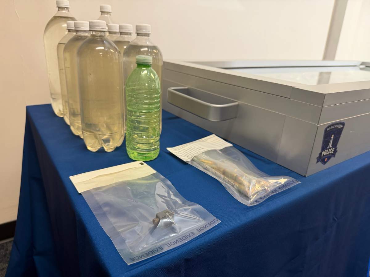 Halifax Regional Police displayed the seized GHB, which was stored in plastic bottles.