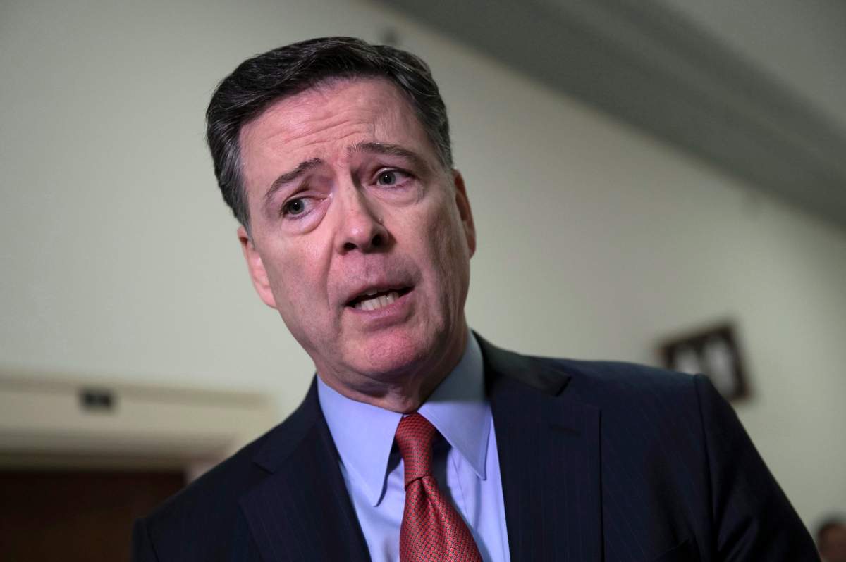 Former FBI Director James Comey speaks to reporters on Capitol Hill Washington, Monday, Dec. 17, 2018.