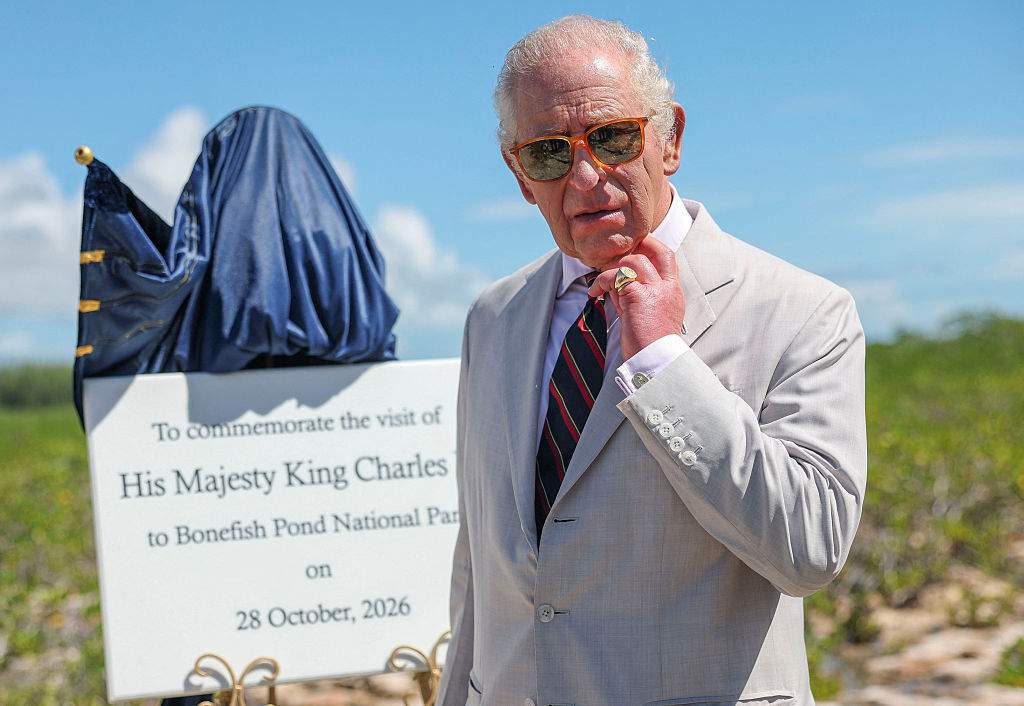 Britain's King Charles III unveils a plaque as he plants a silver buttonwood tree at Bonefish Pond National Park in New Providence during his visit to The Bahamas on October 28, 2026 in Nassau, Bahamas. The King's Autumn Tour includes visits to The Bahamas and Guyana before continuing to Antigua and Barbuda, where he will attend the Commonwealth Heads of Government Meeting.