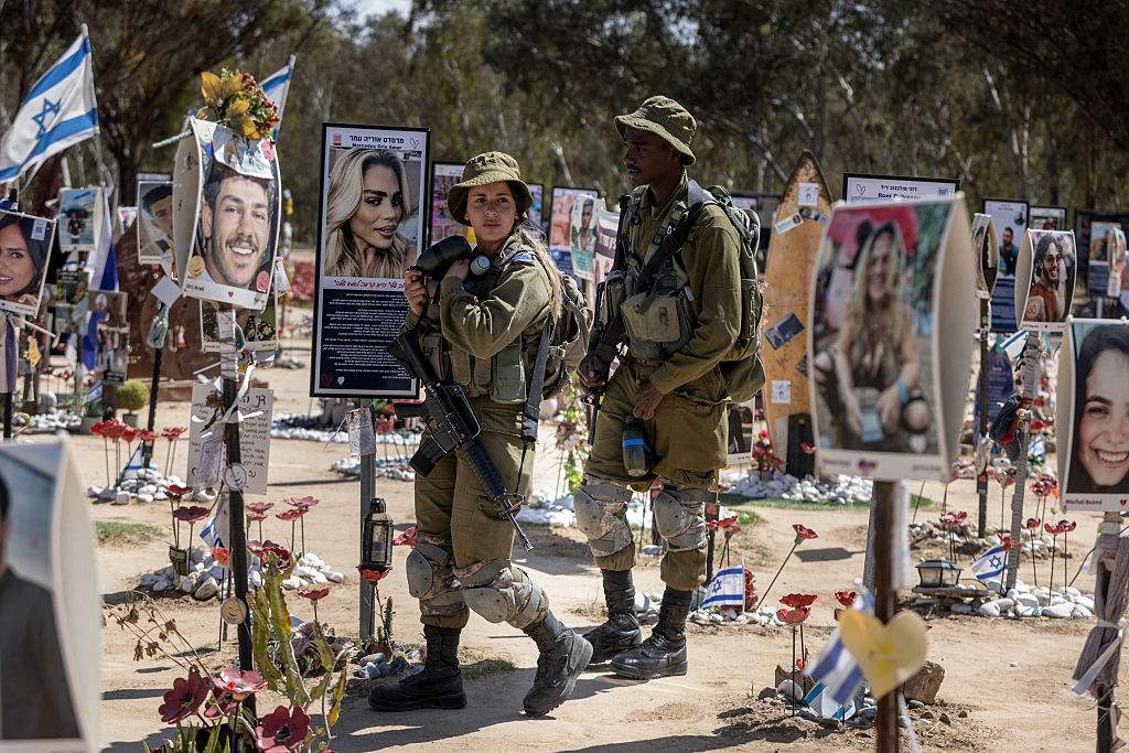 Israeli soldiers patrol at a memorial for the victims at the site of the Nova Music Festival attack that took place on October 7, 2023 by Palestinian militants, in Kibbutz Reim in southern Israel, on March 30, 2025.