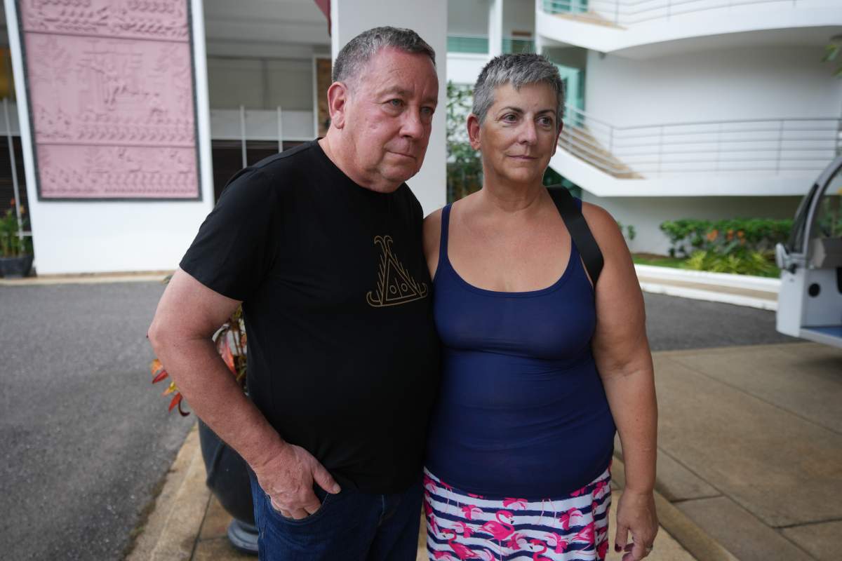 A couple passenger from a U.S. cruise ship, the MV Odyssey, Paul Montoya, left, stands for an interview with his wife, Lynn Motoya, at the Independence Hotel in Sihanoukville, Cambodia, Wednesday, Oct. 28, 2026.
