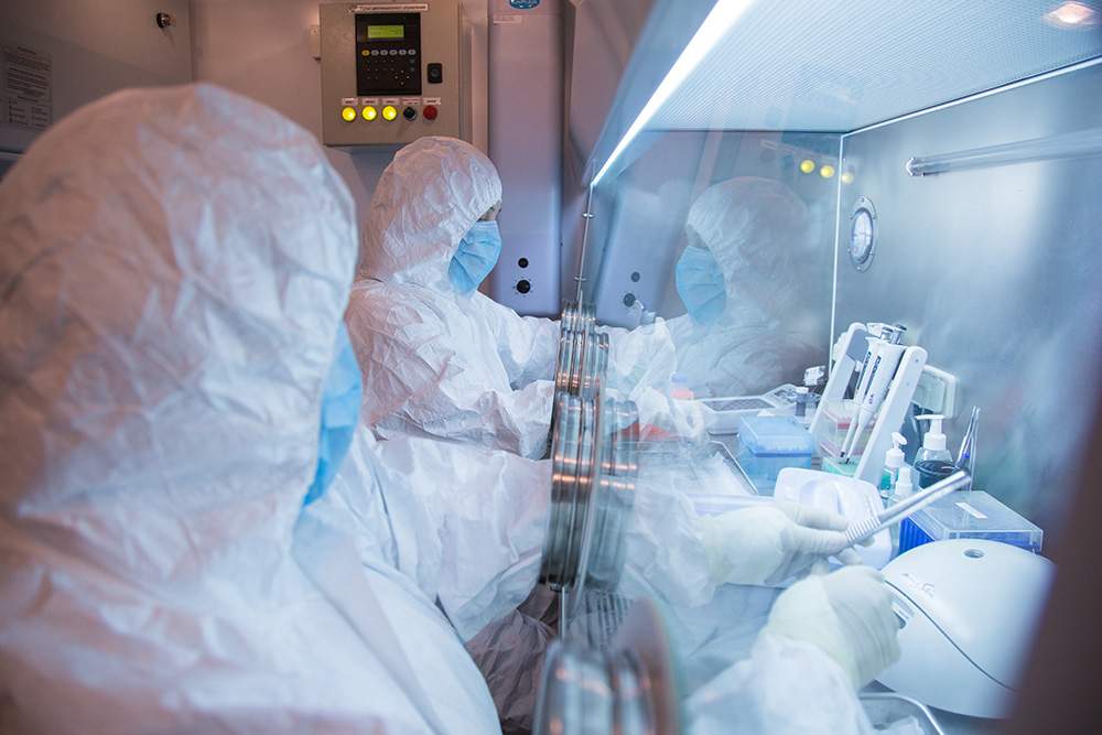 This undated photo released by the Irkutsk Anti-Plague Research Institute of Siberia and Far East, shows the institute workers in a lab.