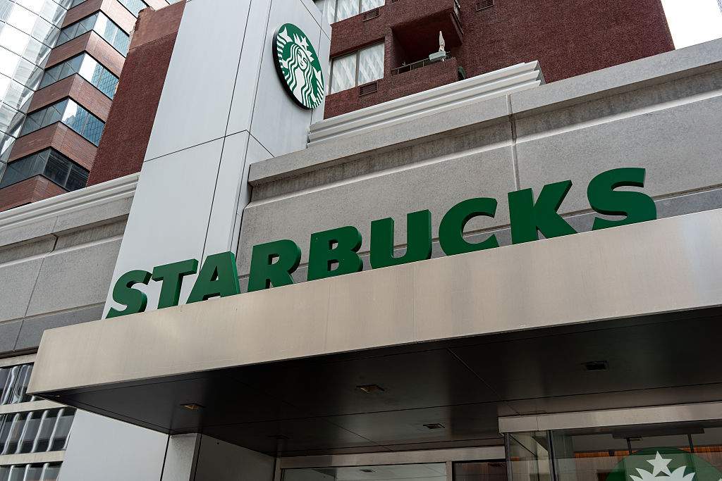 A Starbucks logo sign is seen in New York City, United States, on August 5, 2026. The signage displays the branding of the American coffeehouse chain known for coffee, tea, and other beverages.