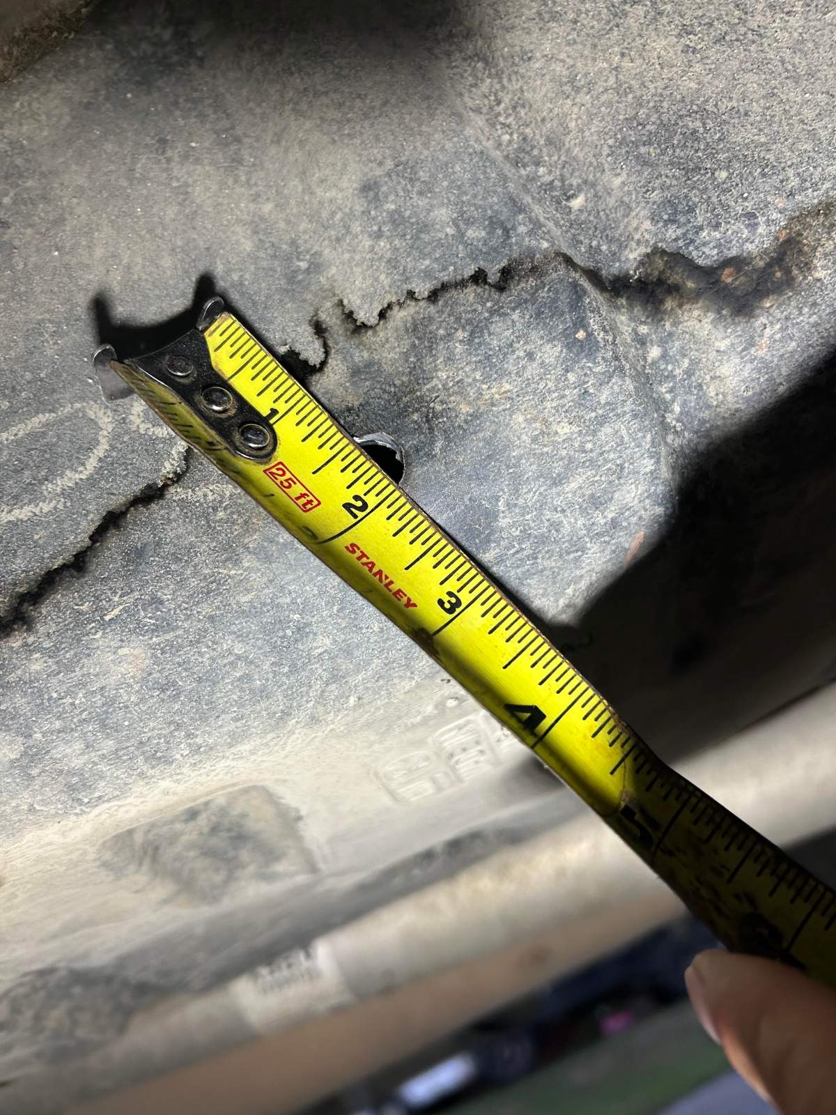 A drill hole from an electric handheld drill in a truck’s fuel tank.