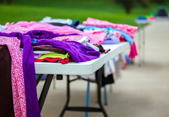 Folding table with clothes for sale