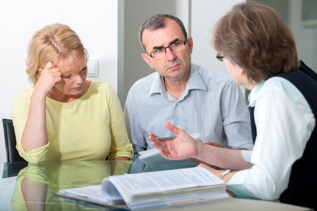 Inheritance disputes - avoiding the war when there's a will Unhappy couple meeting with attorney