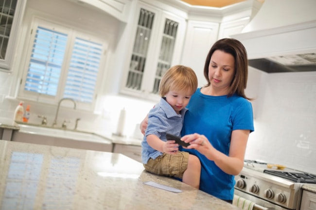 Mother depositing check on smartphone